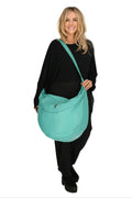 Everyday bag in a balloon shape, made of smooth, high-quality leather, baggy style in turquoise.