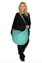Everyday bag in a balloon shape, made of smooth, high-quality leather, baggy style in turquoise.